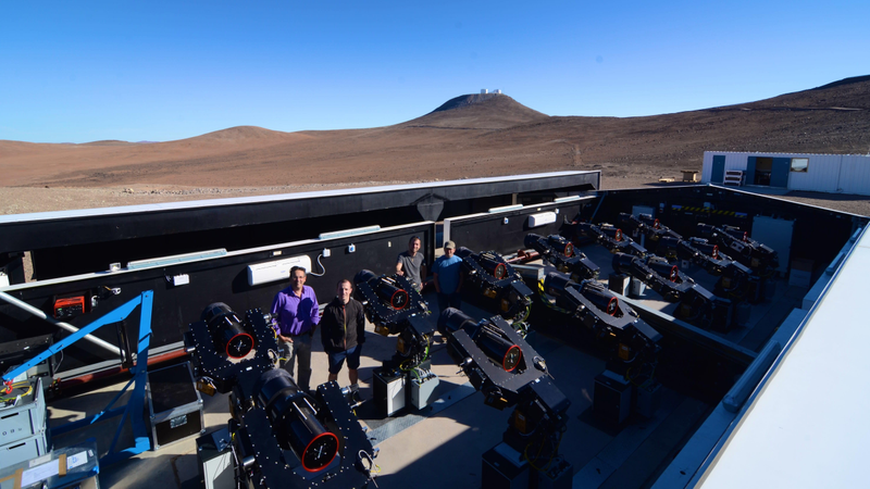 University of Warwick astronomers posing at the Next-Generation Transit Survey (NGTS) in Chile’s Atacama Desert.